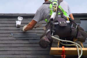 roofing contractor working on a shingle roof repair