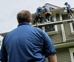 Adam Vaillancourt Roofing site manager overseeing a crew working on a home