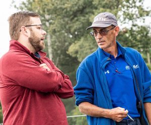 Adam Vaillancourt Roofing specialist talking with a team member on a job site